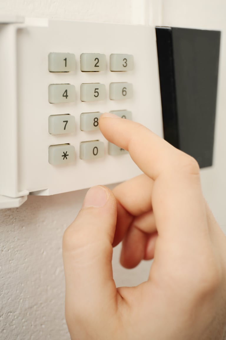 Security Alarm Keypad with Hand Up Close 